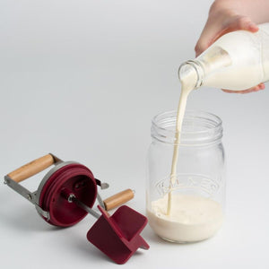 Pouring cream into the Kilner Butter Churner before starting the churning process