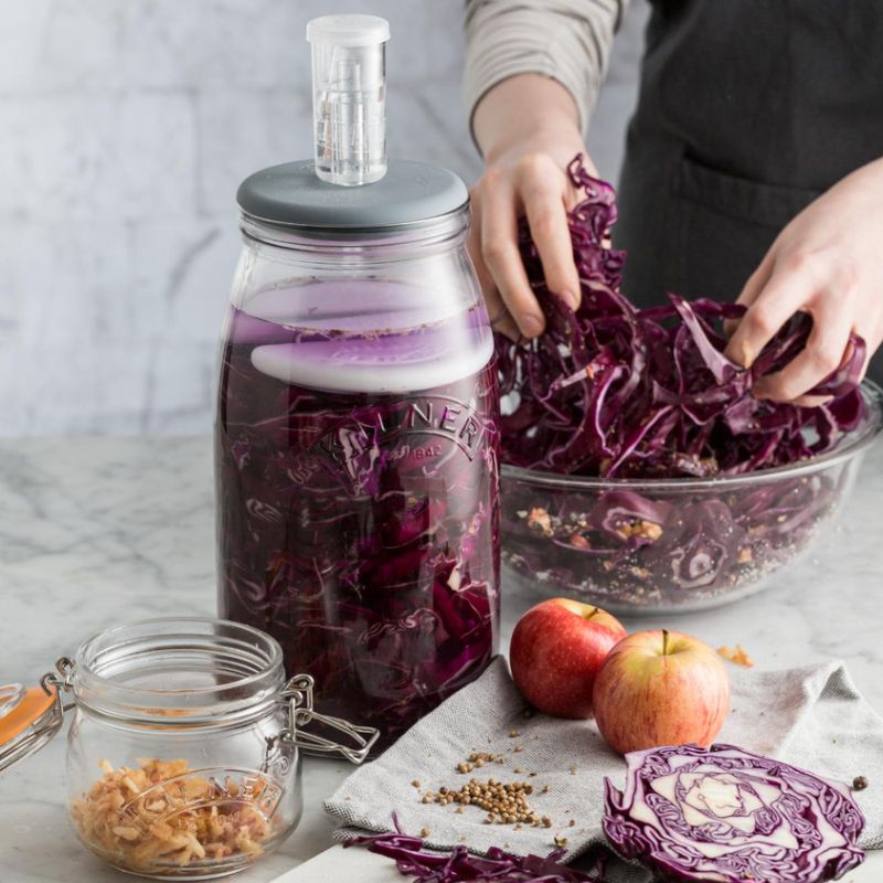 Person preparing purple cabbage for fermentation in the 3L Kilner Glass Fermentation Set