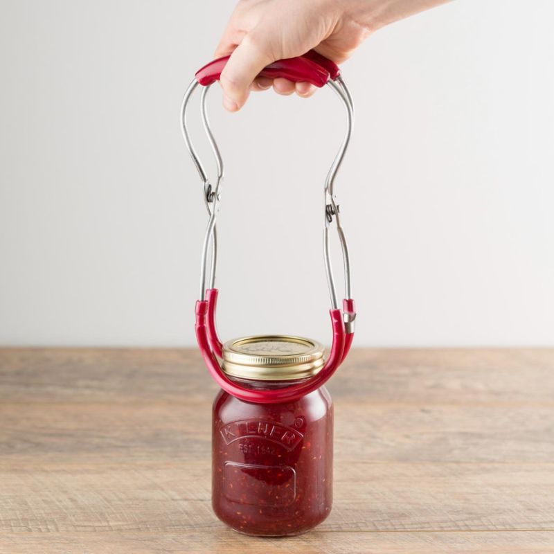 Kilner jar tongs with red handle shown on a white background