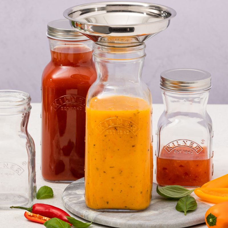 Clear glass Kilner 1L Juice & Sauce Bottle with silver one-piece lid.
