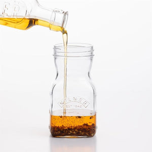 Kilner Salad Dressing Maker shown being filled with oil.
