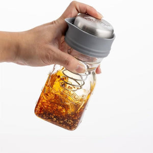 Kilner Salad Dressing Maker being shaken to show how the stainless steel coiled spring mixes the salad dressing.