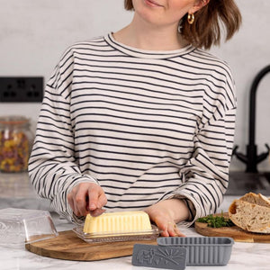 Person cutting butter with the Kilner Silicone Butter Mould on a kitchen counter