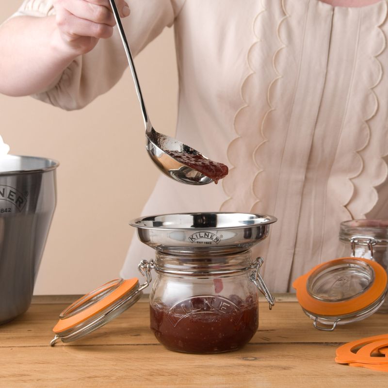 Close-up of jam being poured through Kilner stainless steel funnel into a preserving jar