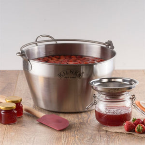 Kilner jam-making equipment with strawberries and jars on a wooden surface - Kilner Stainless Steel Preserving Pan, jar funnel and jars shown.