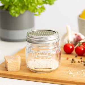Kilner Storage Jar with Fine Grater filled with grated cheese on kitchen bench