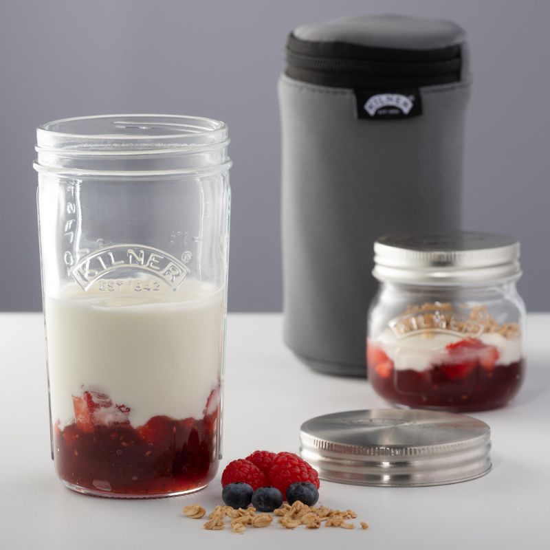 Glass jars filled with homemade yoghurt, fruit and cereal with the Kilner yoghurt making insulating pouch in the background