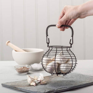 Hand holding Kilo Traditional Garlic Basket filled with garlic bulbs | NZ