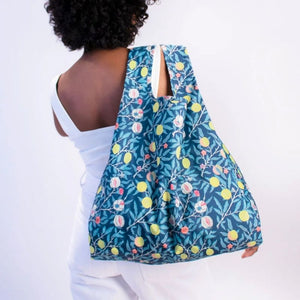 Woman carrying Kind Bag Reusable Shopping Bag in the William Morris Fruits print over her shoulder | NZ