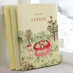 Stack of L’après-Midi undated journals showing illustrated covers