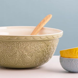 Mason Cash Home To Roost Hen Mixing Bowl in Green (29cm) shown close up on a light blue background.