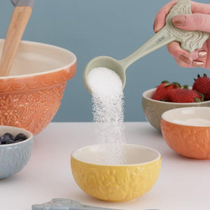 Person pouring sugar into the Mason Cash Home To Roost Prep Bowl in yellow.