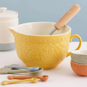 Mason Cash Home To Roost Batter Bowl in yellow shown next to the Home To Roost measuring spoons and prep bowls.