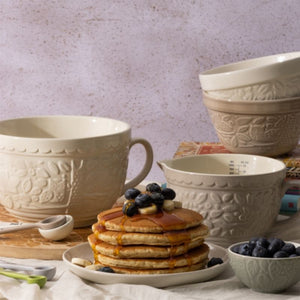 Stack of pancakes with blueberries on a plate, surrounded by a range of Mason Cash ceramics from the In The Forest collection.