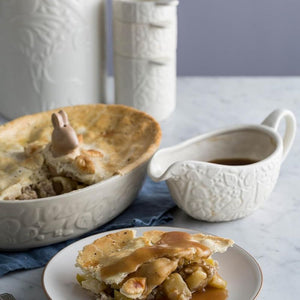Mason Cash In The Forest Gravy Boat styled next to a pie.