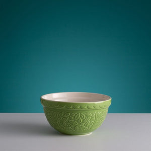 Mason Cash In The Forest Green Hedgehog Mixing Bowl on a grey surface and teal background