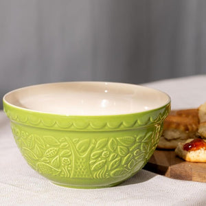 Mason Cash In The Forest Green Hedgehog Mixing Bowl on a white surface with bread in the background