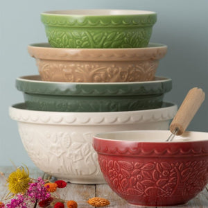 Set of Mason Cash In the Forest mixing bowls in various colours with a wooden spoon on a light grey background.