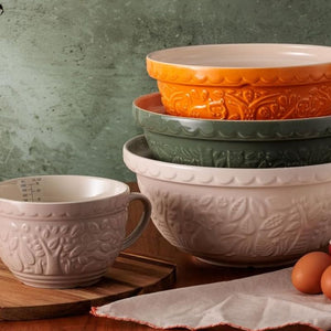 Mason Cash In The Forest Owl Mixing Bowls styled next to eggs against a green background.
