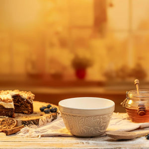 Mason Cash In the Forest Owl Pudding Basin shown on a wooden table with cake, berries, and honey jar.