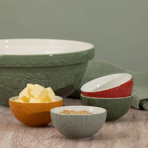 Set of four Mason Cash In The Forest Prep Bowls on a green background.