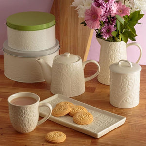 Mason Cash In the Forest collection styled with flowers and cookies.