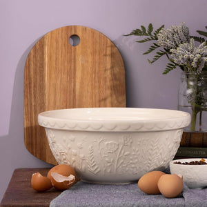 Mason Cash cream mixing bowl styled on a bench with eggs and wooden board - part of the In The Meadow collection.