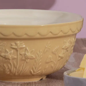 Close-up of the Mason Cash Daffodil yellow mixing bowl showing embossed flower detailing