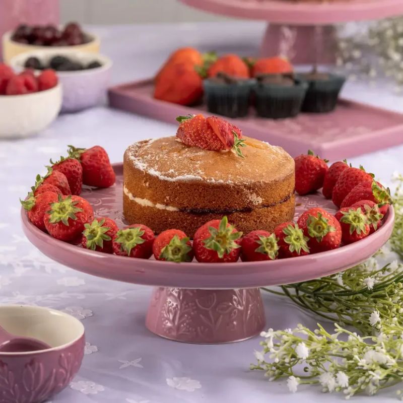 Mason Cash In the Meadow cake stand in Pink, showing embossed floral detailing on the top and base