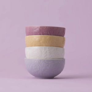 Stack of Mason Cash In the Meadow prep bowls in lilac, cream, yellow, and pink
