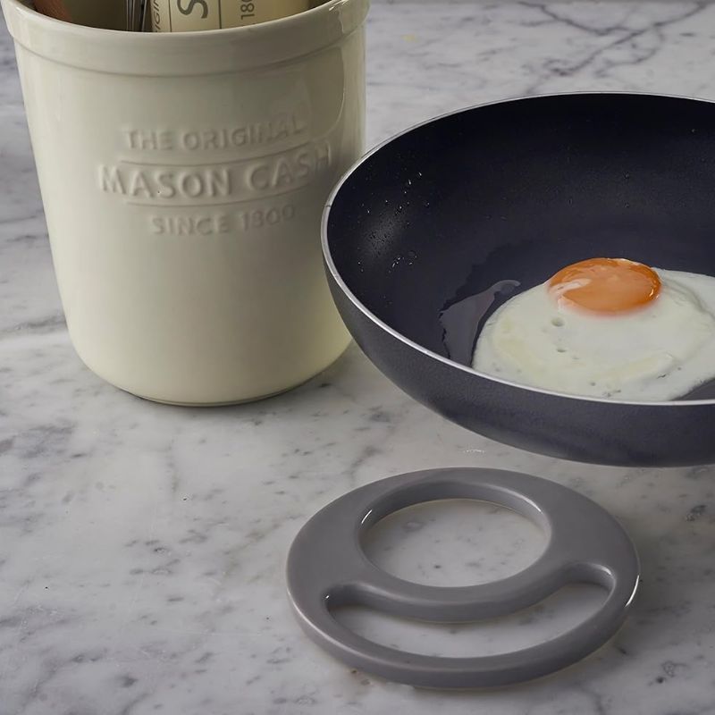 Mason Cash utensil pot with divider removed, used as trivet for hot pan
