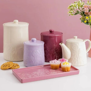 Mason Cash In The Meadow Pink Rectangle Platter styled on table with storage jars and tea pot from the collection behind.