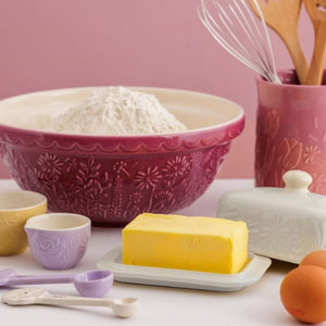 Mason Cash In The Meadow Cream Butter Dish with butter block, shown alongside mixing bowls, eggs, and utensils.