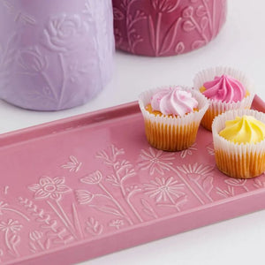 Close up of the Mason Cash In The Meadow Pink Rectangle Platter with cupcakes and matching storage jars