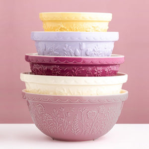 Stack of Mason Cash In the Meadow mixing bowls in assorted colours including pink, cream, yellow, lilac, and berry