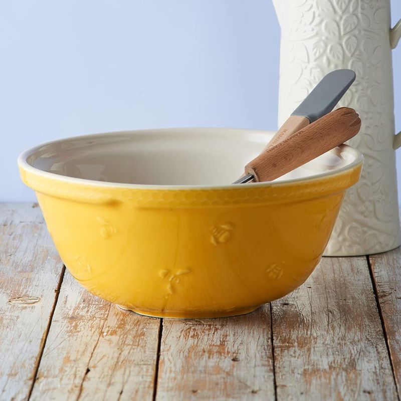 Mason Cash Sweet Bee Mixing Bowl – yellow exterior with bee embossing, whisk  and spatula resting inside.