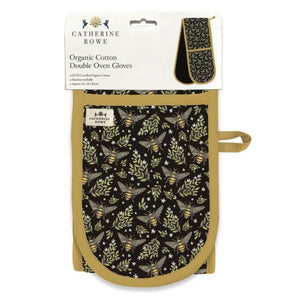 Retail packaging of the Museums & Galleries Catherine Rowe Bee Print Double Oven Glove.