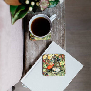 Cup of coffee on the Museums & Galleries Brambly Hedge Coaster placed on a wooden surface.