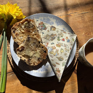 Loaf of bread on a decorative plate with a the Museums & Galleries Brambly Hedge Paper Napkin.