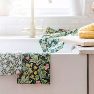 V&A Dearle Designs tea towel draped over a kitchen sink.