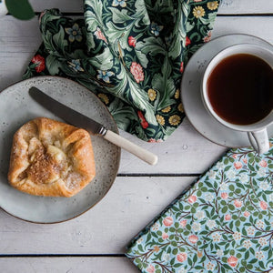 V&A Dearle Designs tea towels with croissant and cup of tea.