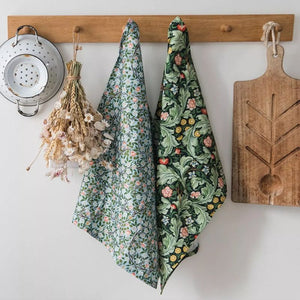 V&A Dearle Designs tea towels hanging on a kitchen hook rail.