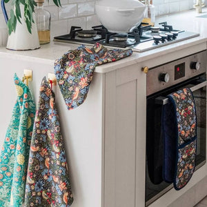 V&A Morris Designs tea towels with matching kitchen linens by the oven.