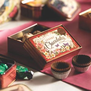 The Nostalgia Small Chocolate Tin in red filled with homemade chocolate truffles.