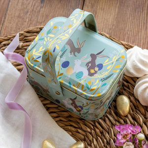 Closed Sara Miller Happy Bunnies Easter Handle Basket displayed on a wooden surface with pastel Easter styling