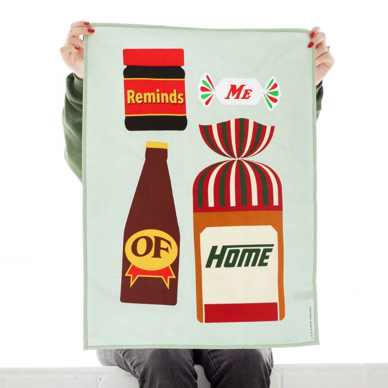 100%NZ Taste of Kiwi Tea Towel featuring Marmite, Mintie, L&P and Vogels bread with the words Reminds Me of Home.