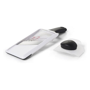 OXO Good Grips Hand Held Mandoline Slicer laid flat with removable safety guard placed beside it.