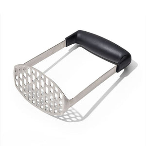 A stainless steel potato masher with a black handle, shown on a clean white background with a soft shadow.