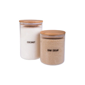 Canisters of coconut and raw sugar displayed with wooden lids and clear vinyl pantry labels by Appetito.