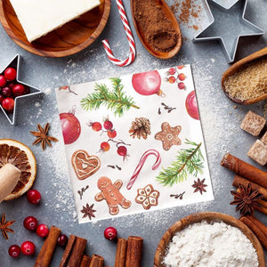 PAW Paper Napkins in the Homemade Sweets pattern, styled in a holiday flat-lay with cinnamon sticks, star-shaped cookie cutters and berries.